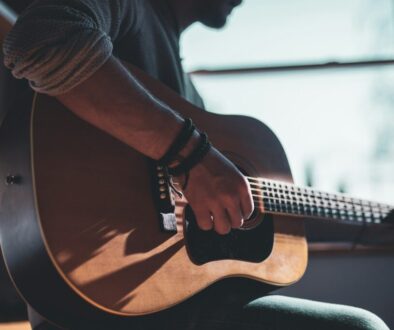 man-playing-acoustic-guitar-selective-focus-photography-hUHzaiAHuUc