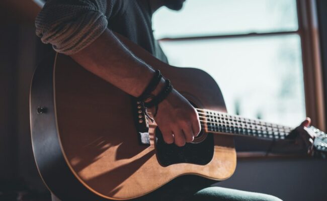 man-playing-acoustic-guitar-selective-focus-photography-hUHzaiAHuUc