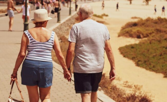 man-and-woman-walking-on-road-while-holding-hands-DLLpNmIG0pk