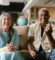 happy-elderly-couple-sitting-on-a-beige-sofa-8139237/